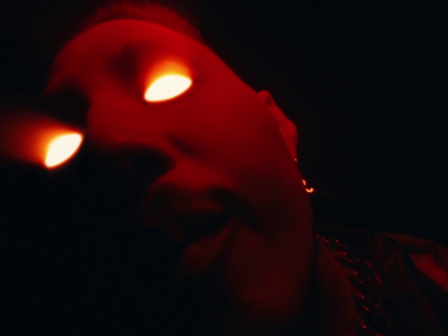 Video Reference: Lip, Mouth, Orange, Entertainment, Flash photography, Beard, Event, Facial hair, Magenta, Darkness