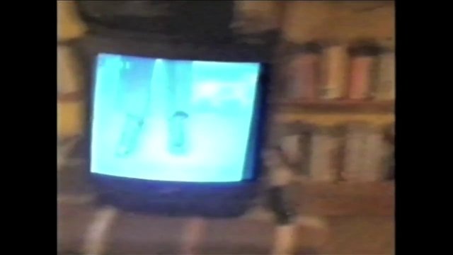 Video Reference: television, CRT, screen, indoor, room, blurry, retro, electronics, old tv, interior, low light, overexposed
