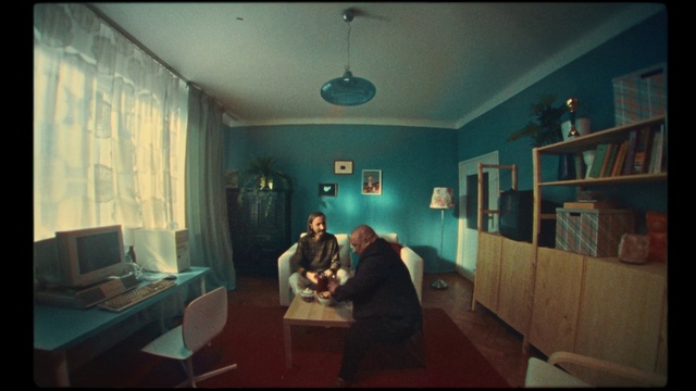 Video Reference: Table, Furniture, Picture frame, Building, Interior design, Houseplant, Comfort, Desk, Living room, Flash photography