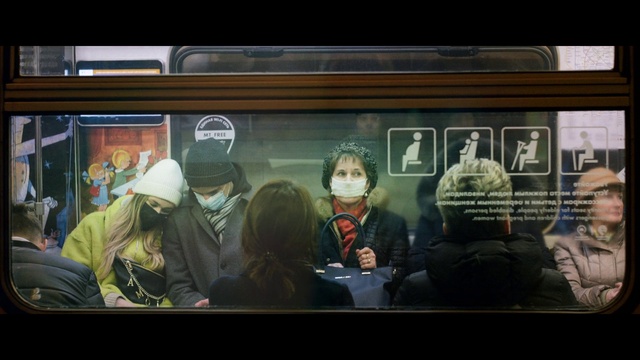 Video Reference: Train, Headgear, Jacket, Public transport, Technology, Display device, Passenger, Electronic device, Font, Fun