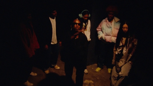 Video Reference: Coat, Entertainment, Performing arts, Fun, Hat, Event, Flash photography, Darkness, Fashion design, Scarf