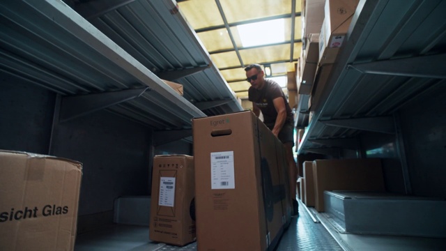 Video Reference: Wood, Floor, Flooring, Shipping box, Hardwood, Package delivery, Air travel, Ceiling, Room, Machine