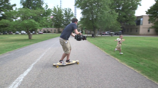 Video Reference: Plant, Skateboard deck, Skateboard truck, Sports equipment, Sky, Wheel, Skateboard, Tree, Skateboarder, Asphalt