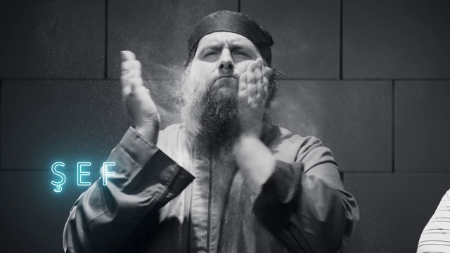 Video Reference: Hand, Outerwear, Arm, Beard, Microphone, Flash photography, Gesture, Audio equipment, Style, Black-and-white