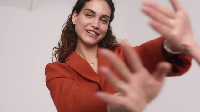 Video Reference: Smile, Hand, Sleeve, Gesture, Happy, Finger, Flash photography, Thumb, Eyelash, Sign language