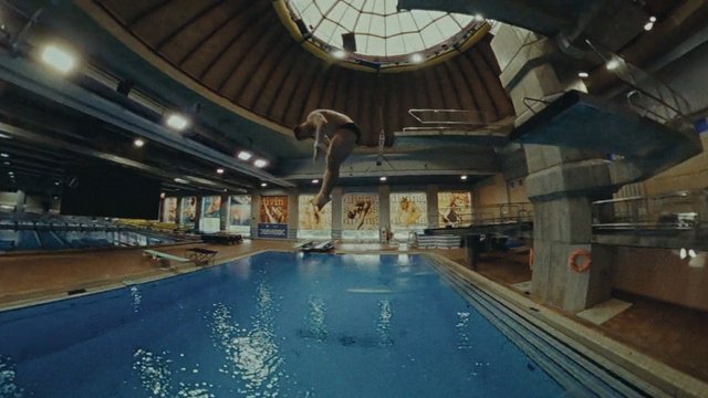 Video Reference: indoor pool, swimming pool, diving, diver, athlete, sports, water, aquatic, training, leisure, wide angle, interior, pool deck, action, jump, fitness