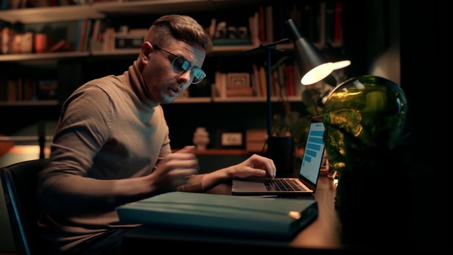 Video Reference: Computer, Personal computer, Table, Laptop, Shelf, Tableware, Bookcase, Eyewear, Musician, T-shirt