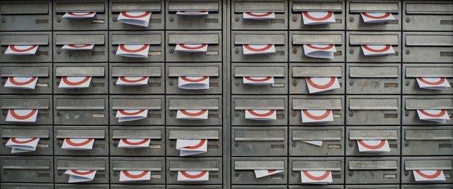Video Reference: mailboxes, mailbox, paper notices, envelopes, urban, metal, row, pattern, repetition, mail slots, grime, office, residential, front view