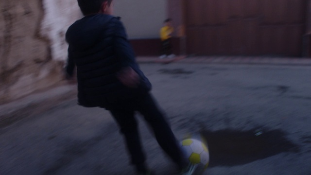 Video Reference: Leg, Soccer, Sports equipment, Football, Ball, Asphalt, Soccer ball, Player, Tints and shades, Knee