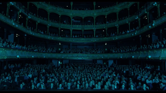 Video Reference: Blue, Building, Entertainment, Performing arts, Performing arts center, Event, Crowd, Projection screen, Sport venue, Display device