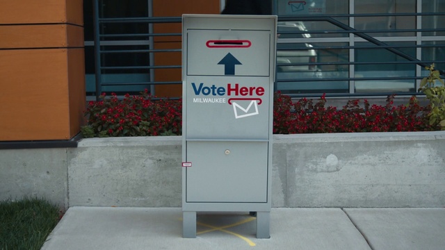 Video Reference: Plant, Fixture, Rectangle, Font, Gas, Building, Composite material, Road surface, Sidewalk, Door