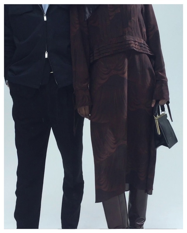 Video Reference: Outerwear, Street fashion, Neck, Sleeve, Textile, Waist, Gesture, Collar, Thigh, Knee