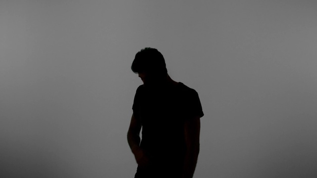 Video Reference: Flash photography, Neck, Sleeve, Gesture, Grey, Elbow, T-shirt, Sky, Facial hair, Backlighting