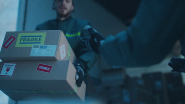 Video Reference: Gadget, Event, Personal protective equipment, Space, Electric blue, Font, T-shirt, Box, Shipping box, Audio equipment