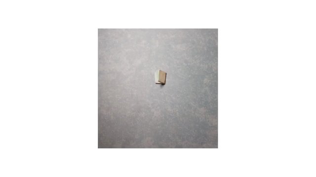 Video Reference: abstract, minimal, small object, gray background, texture, centered, isolated, simple, neutral, close-up, empty space