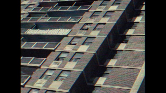 Video Reference: Building, Property, Window, Sky, Rectangle, Tower block, Urban design, Condominium, Material property, Symmetry