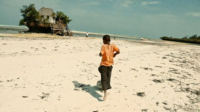Video Reference: beach, child, running, sand, shoreline, ocean, coast, island, hut, boat, travel, tropical, outdoors, summer, seascape, landscape