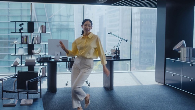 Video Reference: Shoulder, Smile, Cabinetry, Standing, Flooring, Table, Automotive design, White-collar worker, Fashion design, Event