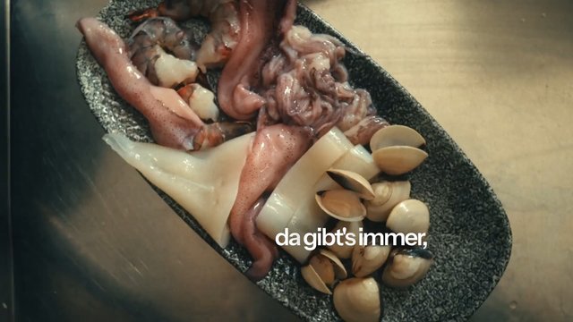 Video Reference: seafood, raw, squid, octopus, clams, shellfish, platter, food, close-up, cooking, restaurant, overlay text, ingredients, uncooked, gourmet
