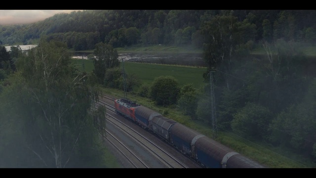 Video Reference: Train, Plant, Vehicle, Tree, Atmospheric phenomenon, Rolling, Slope, Thoroughfare, Track, Grass