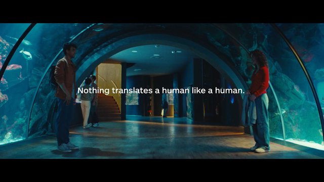 Video Reference: aquarium, tunnel, fish, indoor, people, text overlay, museum, underwater, blue lighting, interior, commercial, travel