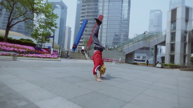 Video Reference: Plant, Building, Skyscraper, Sky, Tree, Street stunts, Tire, Performing arts, Leisure, Entertainment