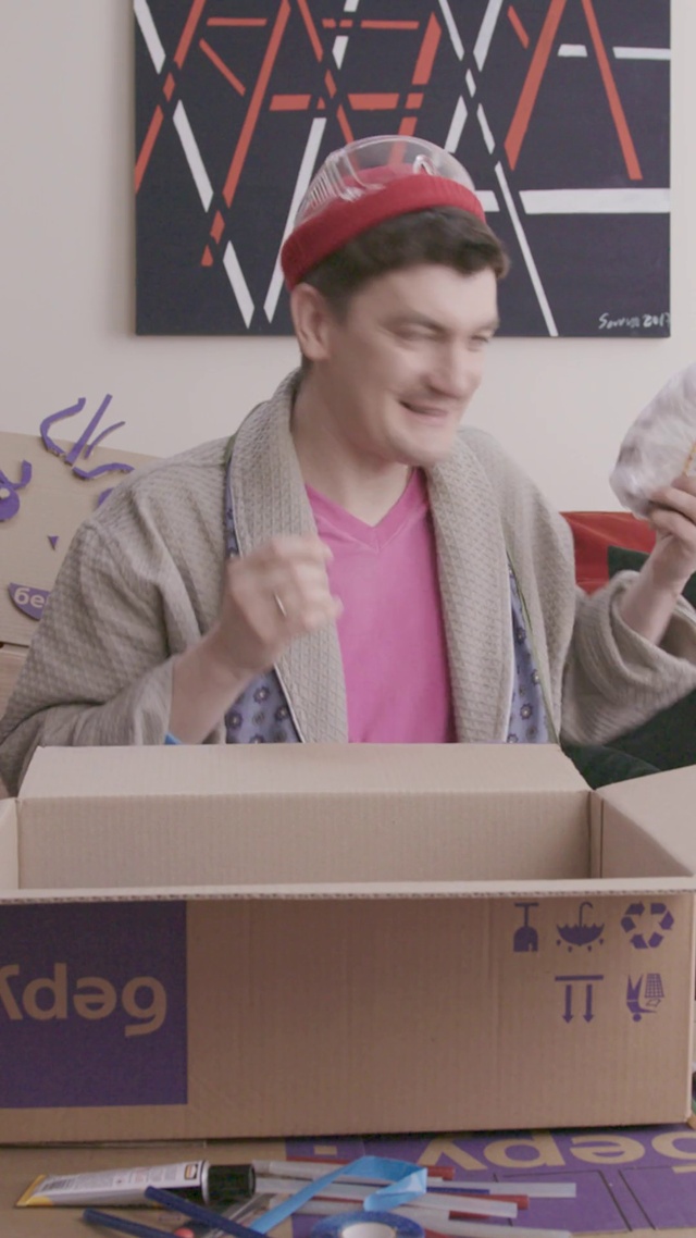 Video Reference: Smile, Cap, Baseball cap, Gesture, Shipping box, Packing materials, Carton, Output device, Packaging and labeling, Event