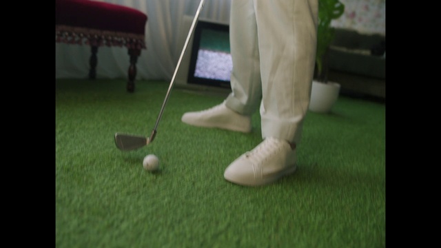 Video Reference: Golf, Golf equipment, Golf ball, Sports equipment, Floor, Knee, Golf club, Grass, Flooring, Precision sports