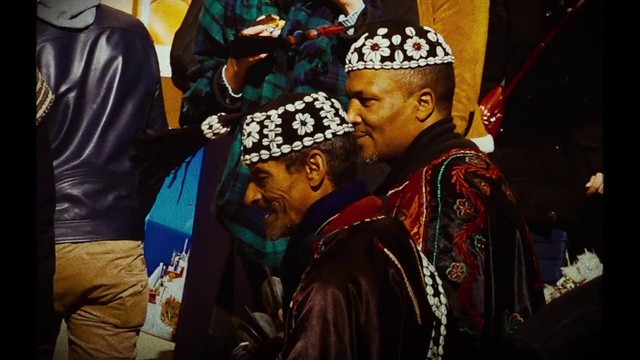 Video Reference: Temple, Sleeve, Headgear, Cap, Event, Jewellery, Tradition, Crowd, Fashion accessory, Entertainment