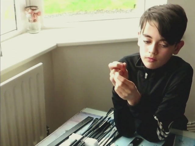 Video Reference: Hand, Gesture, Finger, Office supplies, T-shirt, Thumb, Wrist, Office equipment, Table, Room