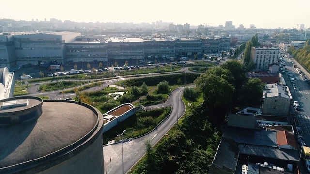 Video Reference: Building, Sky, Daytime, Plant, Tower, Infrastructure, Urban design, Road surface, Tower block, Tree