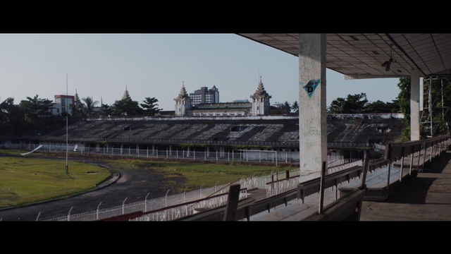 Video Reference: Sky, Building, City, Grass, Fence, Bridge, Asphalt, Overpass, Sport venue, Race track