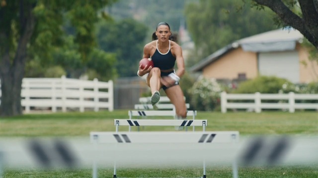 Video Reference: Hurdling, Obstacle race, Sports equipment, Hurdle, Track and field athletics, Shorts, Watch, Multi-sport event, Race track, Plant