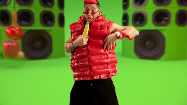 Video Reference: Hand, Muscle, Green, Microphone, Public address system, Standing, Gesture, Yellow, Performing arts, Entertainment