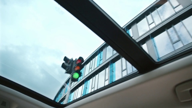 Video Reference: Sky, Building, Window, Cloud, Automotive exterior, Glass, Automotive design, Facade, Windshield, Vehicle door