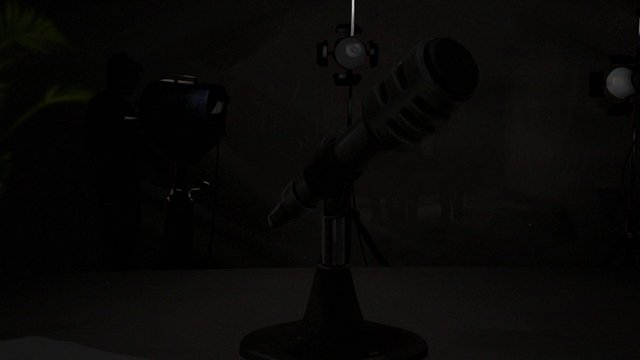 Video Reference: dark, indoor, camera, tripod, telescope, studio, equipment, lighting, silhouette, low_light, electronics, apparatus