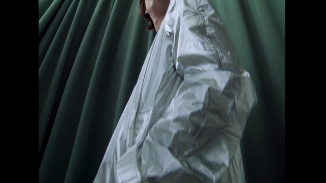 Video Reference: Shoulder, Dress shirt, Window, Sleeve, Gesture, Tints and shades, Formal wear, Curtain, Bridal accessory, Event