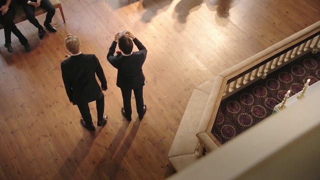 Video Reference: Trousers, Shoe, Gesture, Wood, Flooring, Suit, Font, Hardwood, Art, Event