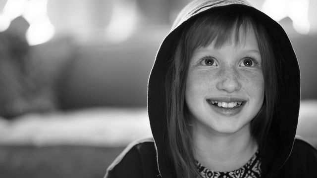 Video Reference: Face, Lip, Outerwear, Eyebrow, Smile, White, Black, Flash photography, Happy, Standing