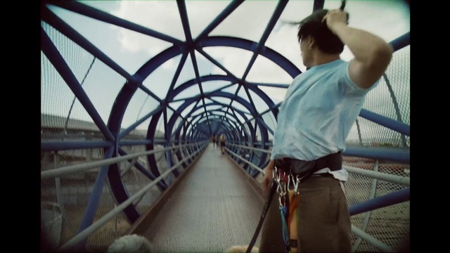 Video Reference: Sky, Shorts, Flash photography, Symmetry, Metal, Leisure, T-shirt, Bridge, Nonbuilding structure, Fence