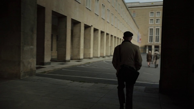 Video Reference: Building, Window, Road surface, Grey, Street fashion, Sidewalk, Tints and shades, City, Waist, Road