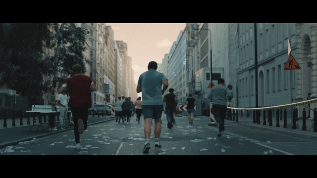 Video Reference: Building, Shorts, Sky, Human, Asphalt, Road surface, Outdoor recreation, Tree, Sports, Road