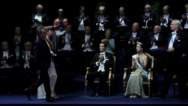 Video Reference: Entertainment, Suit, Music, Formal wear, Chair, Event, Performing arts, Fashion design, Uniform, Musical instrument accessory