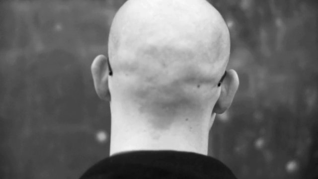 Video Reference: black and white, rear view, bald head, close up, portrait, neck, ears, blurred background, minimal, monochrome, human, back view