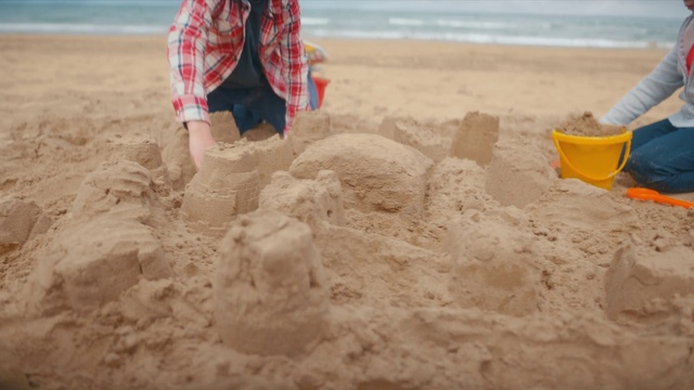 Video Reference: Water, Beach, Building sand castles, People on beach, Sand, Summer, Recreation, Fun, Soil, Travel