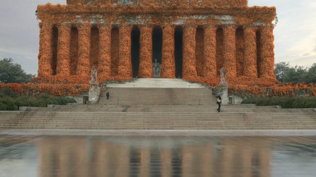 Video Reference: monument, columns, flowers, floral decoration, steps, architecture, landmark, outdoor, symmetry, wide shot, reflection, garden, historic, travel