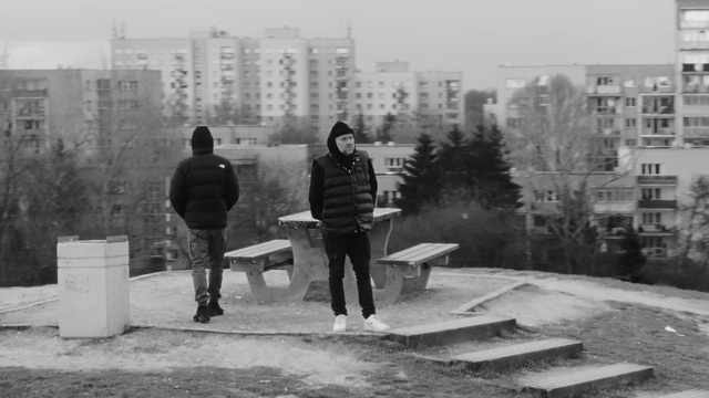 Video Reference: Jeans, Building, Human, Infrastructure, Black-and-white, Standing, Sky, Grey, Style, Road surface