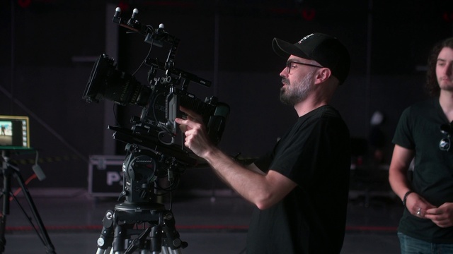 Video Reference: Videographer, Tripod, Flash photography, Television crew, Camera accessory, Film crew, Video camera, Baseball cap, Cinematographer, Cap