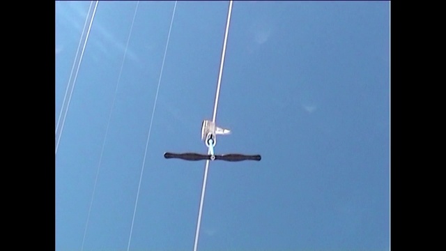 Video Reference: Sky, Electric blue, Event, Public utility, Pole, Electricity, Balance, Composite material, Symmetry, Wire