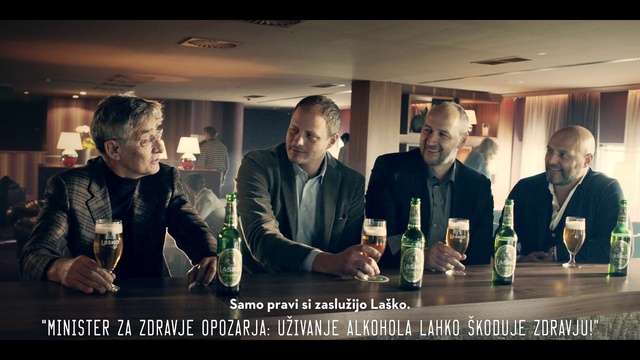 Video Reference: Tie, Drink, Coat, Flash photography, Sharing, Bottle, Alcoholic beverage, Interaction, Formal wear, Friendship